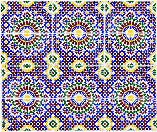 Beautiful Islamic mosaic pattern in Moroccan style. Mosaic oriental ornaments can be found in mosques, important buildings and drinking fountains on the street. Fes, Morocco. © olenatur