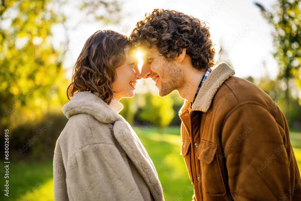 Portrait of happy loving couple in park in sunset. Portrait of happy loving couple in park in sunset.