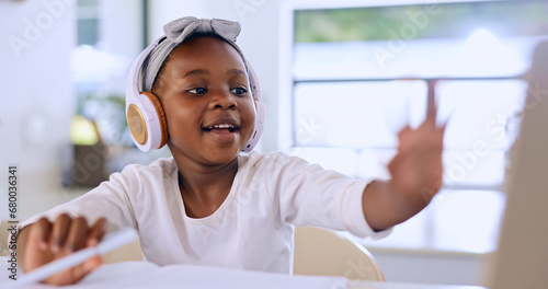 Black child, headphones and learning in video call, studying and homework in house. African kid in virtual class, distance education and listening to lecture, music and writing notes in home school