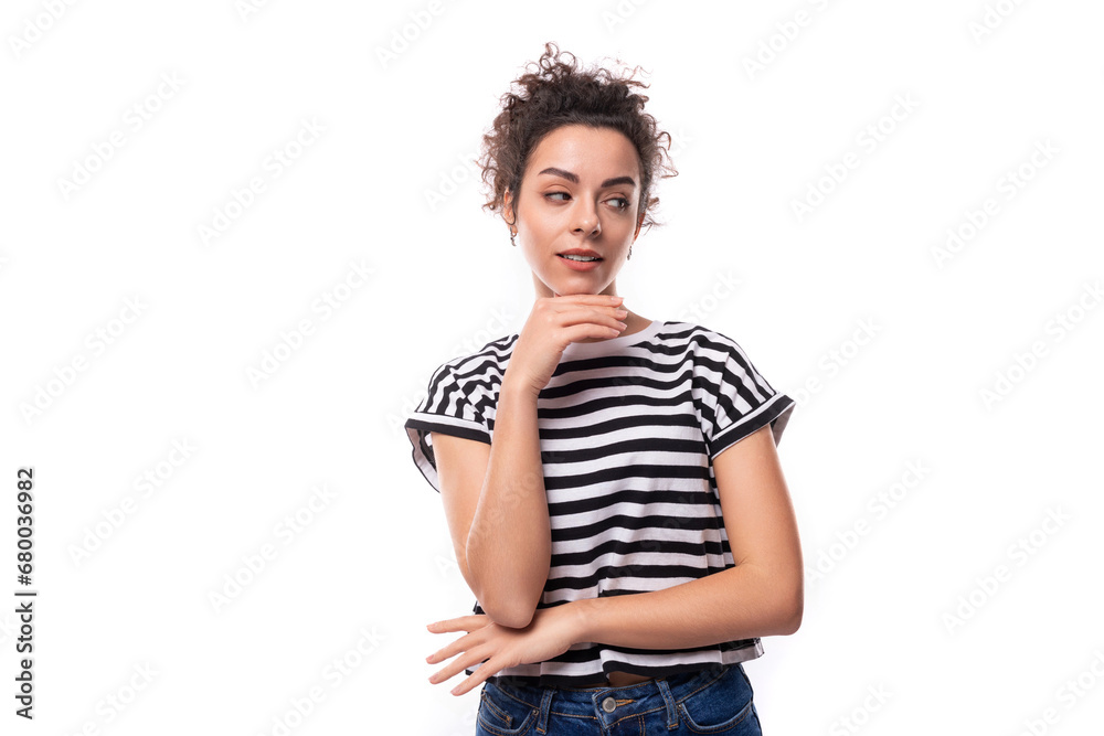 young caucasian woman with curly black hair dressed in a striped black and white t-shirt is brainstorming young caucasian woman with curly black hair dressed in a striped black and white t-shirt is brainstorming
