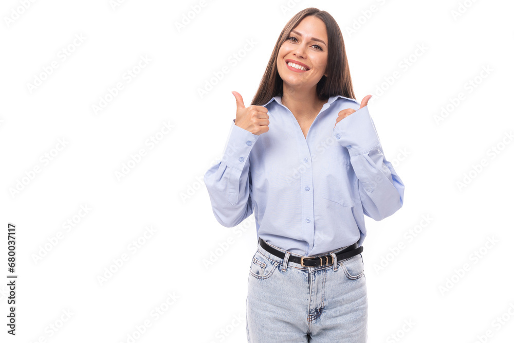 charming pretty young brunette caucasian woman with straight hair is dressed in a sky blue shirt on a white background with copy space charming pretty young brunette caucasian woman with straight hair is dressed in a sky blue shirt on a white background with copy space
