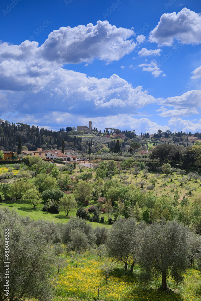 Typical rural panorama of the Florentine hills. Typical Tuscan hilly landscape with rows of cypresses and olive trees seen from the Boboli Gardens in Florence, Italy.	