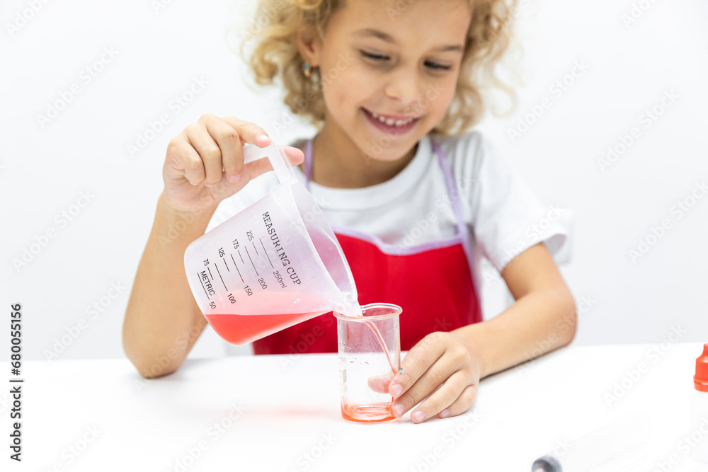 Little girl doing chemical experiment in laboratory at school on white background. Toddler child wants to become a scientist, study dropping liquid to test tube, biochemistry . chemistry class. Little girl doing chemical experiment in laboratory at school on white background. Toddler child wants to become a scientist, study dropping liquid to test tube, biochemistry . chemistry class.