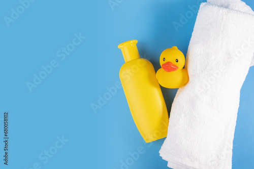 Towel, baby shampoo, and rubber duck, hygiene care for newborns, adorable bath set photo