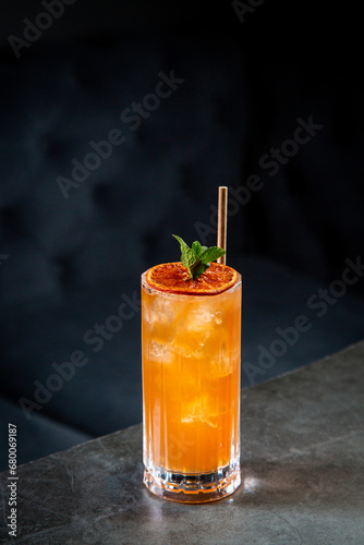tropical cocktail with sunset gradient and citrus side view