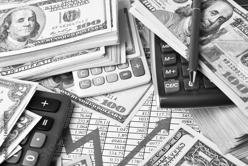 Paper money dollar banknotes, graph and calculators photo