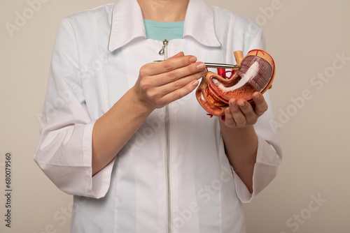 Photos woman doctor pointing at stomach mockup