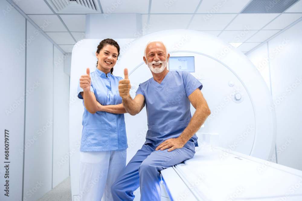 Fototapeta premium Doctor and patient holding thumbs up in MRI scanning room.