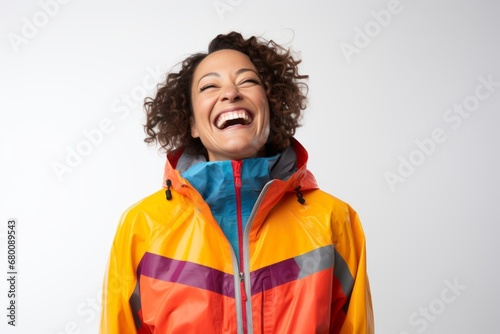 Portrait of a joyful woman in her 40s wearing a vibrant raincoat against a white background. AI Generation