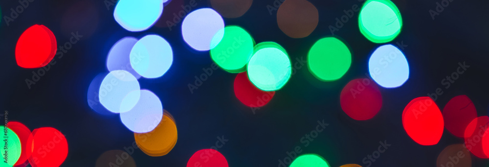 Banner. Colourful festive bokeh lights on background. Abstract multicolored light. Christmas or New Year holiday concept. Mock up template for greeting card