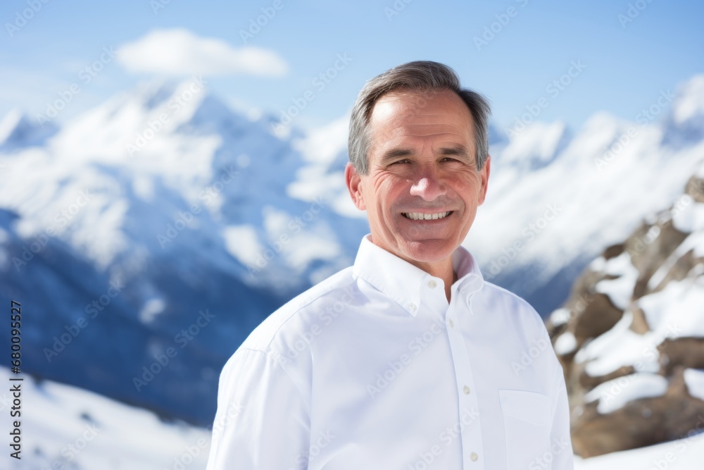 Portrait of a grinning man in his 50s wearing a classic white shirt against a snowy mountain range. AI Generation Portrait of a grinning man in his 50s wearing a classic white shirt against a snowy mountain range. AI Generation