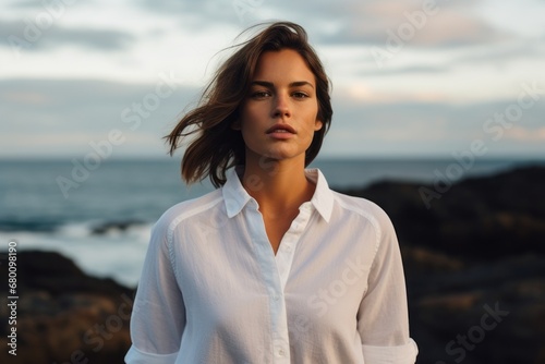 Portrait of a content woman in her 20s wearing a simple cotton shirt against a stunning ocean reef. AI Generation © CogniLens
