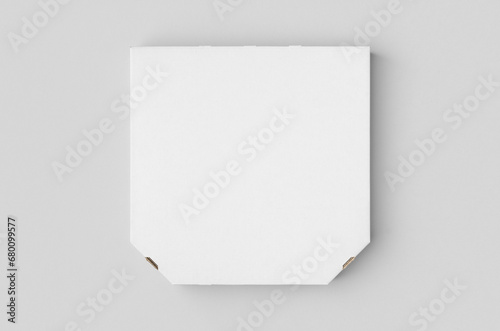 White blank pizza box mockup on a grey background. © Shablon