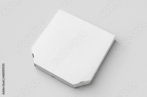 White pizza box mockup on a grey background. © Shablon