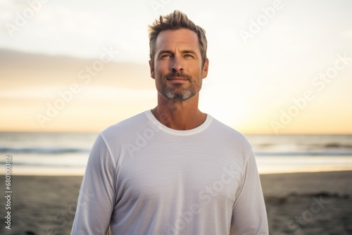 Portrait of a blissful man in his 40s sporting a long-sleeved thermal undershirt against a beautiful beach sunset. AI Generation © CogniLens