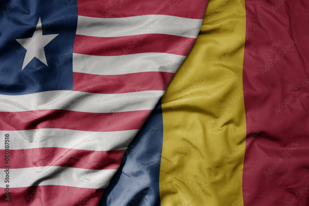 Obraz premium big waving national colorful flag of chad and national flag of liberia .