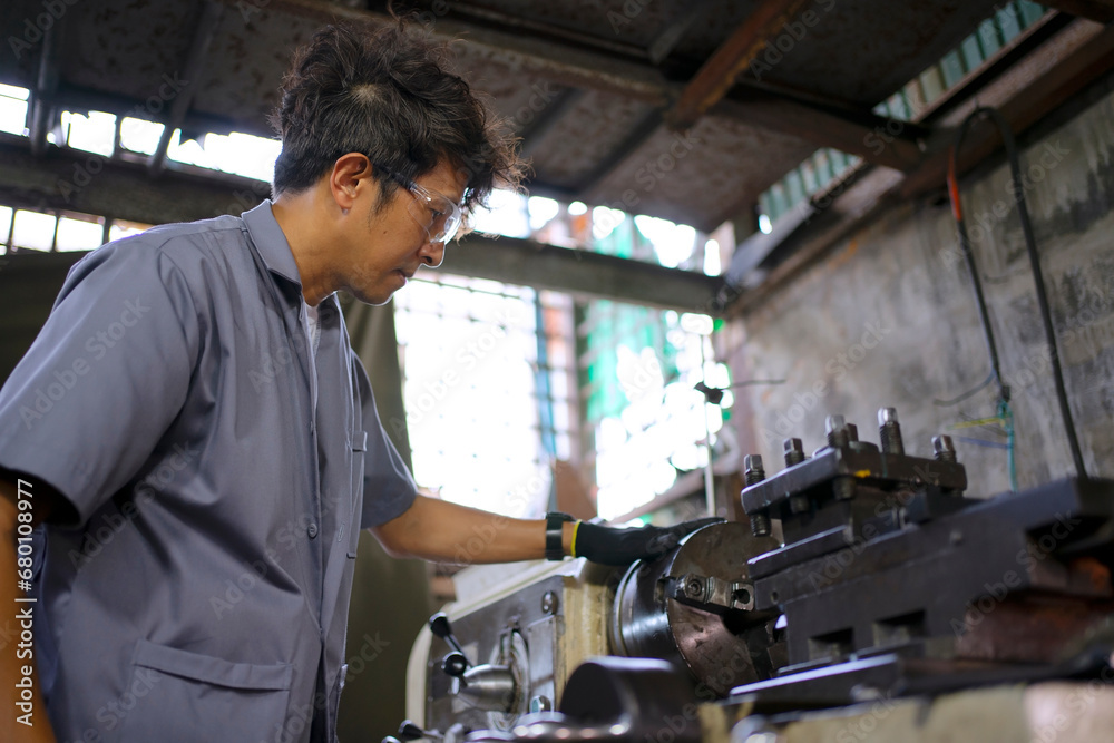 Trainee works at machine shop. Trainee works at machine shop.