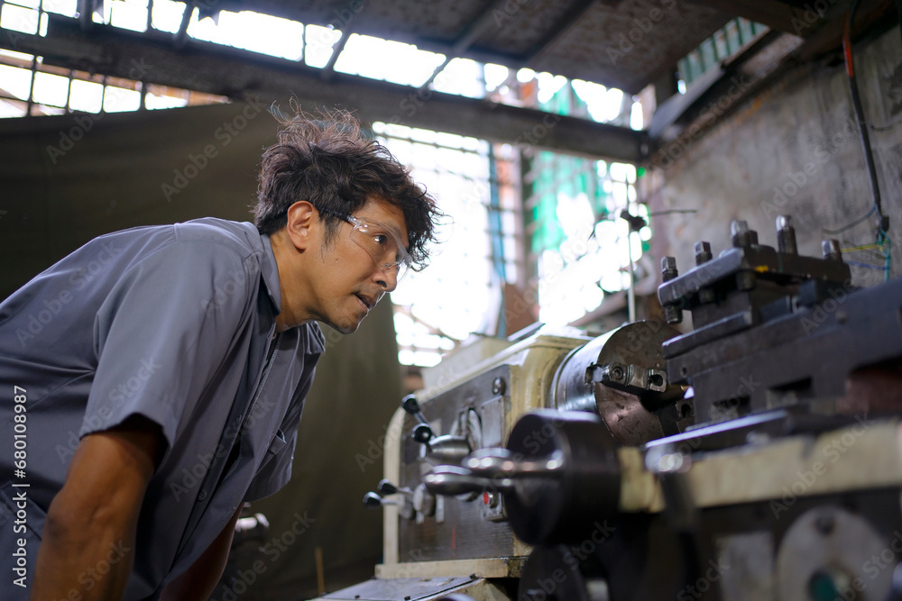 Trainee works at machine shop.