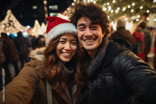 Happy Asian couple celebrating Christmas night together in the city. Celebration, holiday concept