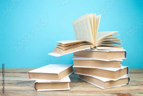 open book, books on the blue background. Back to school. Education. Copy space for text.