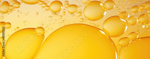 Yellow bubbles in beer or oil.  Droplets panorama.