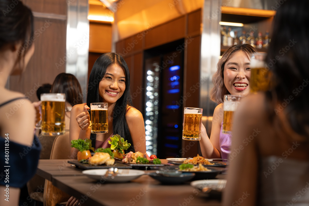 Beautiful Asian Woman Enjoying with Friend in Bar. They Drinking Cocktail Together in Bar Counter. Party, Lifestyle, Happiness, Cheerful and Celebration Concept.