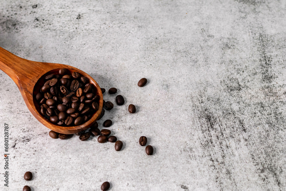 High angle shot of coffee beans in wooden spoon with copy space. High angle shot of coffee beans in wooden spoon with copy space.