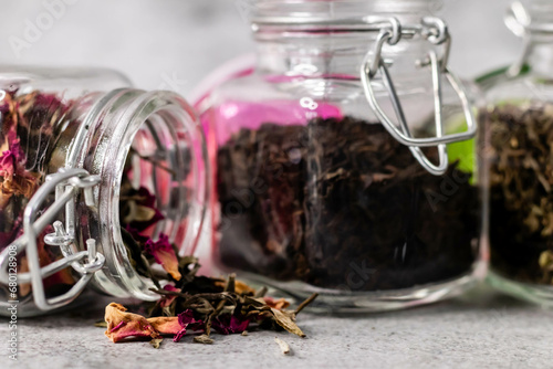 Zoom in shot of jar with dry scattered rose petels and defocused jars in the background. photo