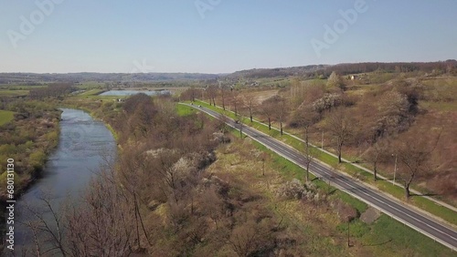 Panorama of road from a bird's eye view. Central Europe: town or village is located among the green hills. Temperate climate. Flight drones or quadrocopter.