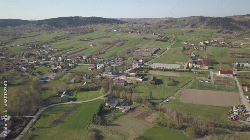 Panorama from a bird's eye view. Central Europe: The Polish village is located among the green hills and river. Temperate climate. Flight drones or quadrocopter. Urbanization of the landscape. Panorama from a bird's eye view. Central Europe: The Polish village is located among the green hills and river. Temperate climate. Flight drones or quadrocopter. Urbanization of the landscape.