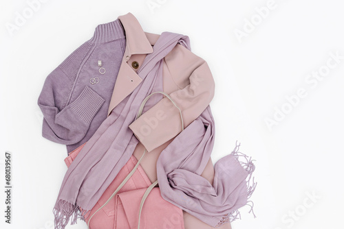 Classic pale pink trench coat with purple jumper, scarf and loafers. Fashion spring or autumn outfit. Women's stylish and elegant clothes with accessory.  Flat lay, top view, overhead.
