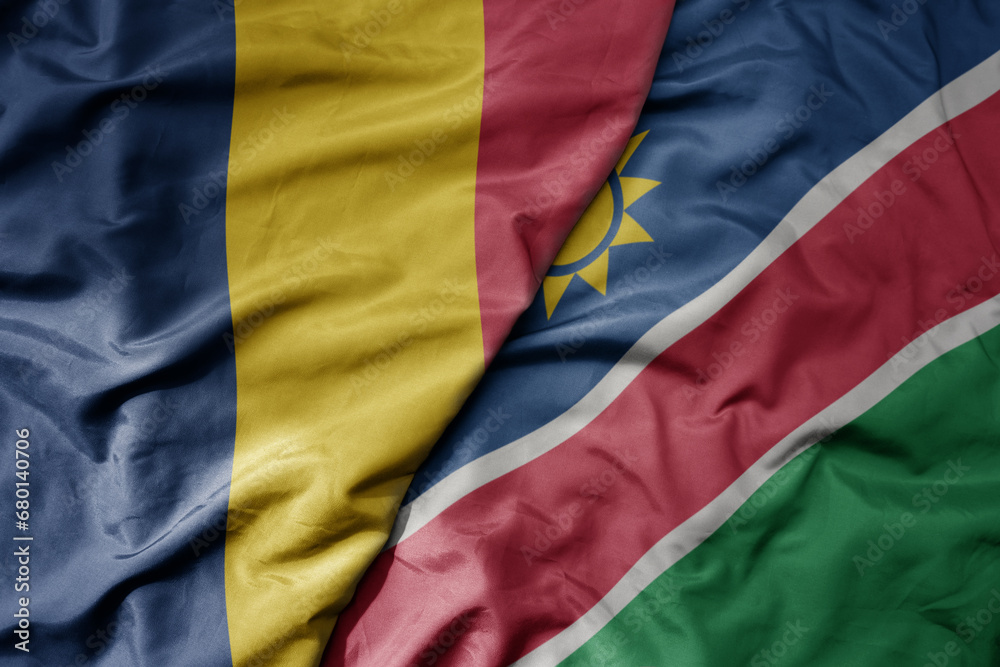 Fototapeta premium big waving national colorful flag of namibia and national flag of chad .