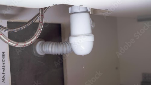 Leaking siphon in the sink. Broken siphon. Sewage leakage. Leak.