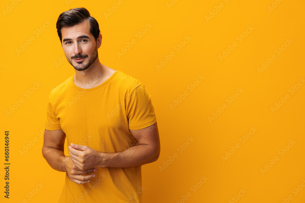 Man studio yellow style arm portrait background smiling confident space laughing lifestyle copy gesture trendy fashion