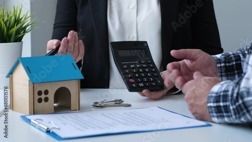 Real estate agent talking to home buyer and offer good property value on calculator. Insurance broker consulting client and giving advice to customer about buying or renting house photo