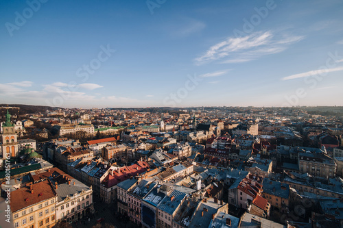 View of the old city from above, from the observation tower of the town hall. Roofs of houses in the evening. Ukraine, Lviv Latin Cathedral of the Assumption of the Virgin Mary, winter panorama.