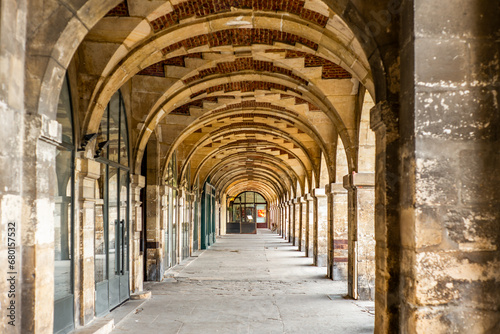 The arcade in the Place des Vosges in Paris © gdefilip