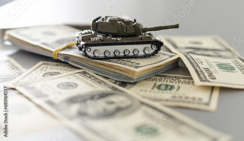 Tank on dollar bills. The concept of war costs, military spending. photo