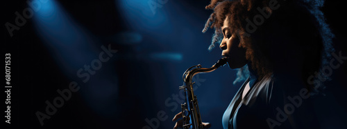 Afro-American Woman with Beautiful curly hair Playing the Saxophone at a Vibrant Jazz Concert, profile photography isolated on a dark blue and black background 