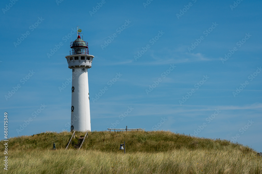 Beautiful white lighthouse in dutch coastal village of Egmond aan Zee, Province North Holland