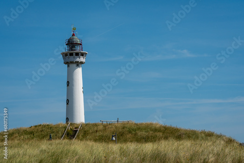 Beautiful white lighthouse in dutch coastal village of Egmond aan Zee, Province North Holland