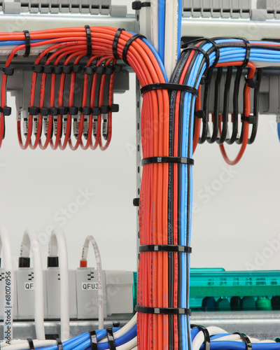 Stranded mounting wires assembled into a bundle with plastic ties. View from the back of the electrical switchboard. © Нелик Дулатов