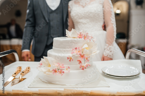 beautiful wedding cake on the background of the newlyweds
