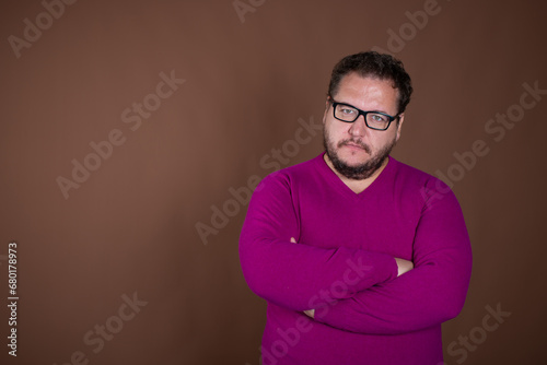 Funny fat man posing in studio on brown background. Different emotions. © vladorlov
