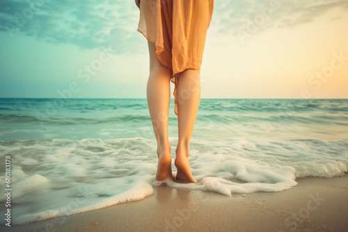 Feet in sand by the ocean