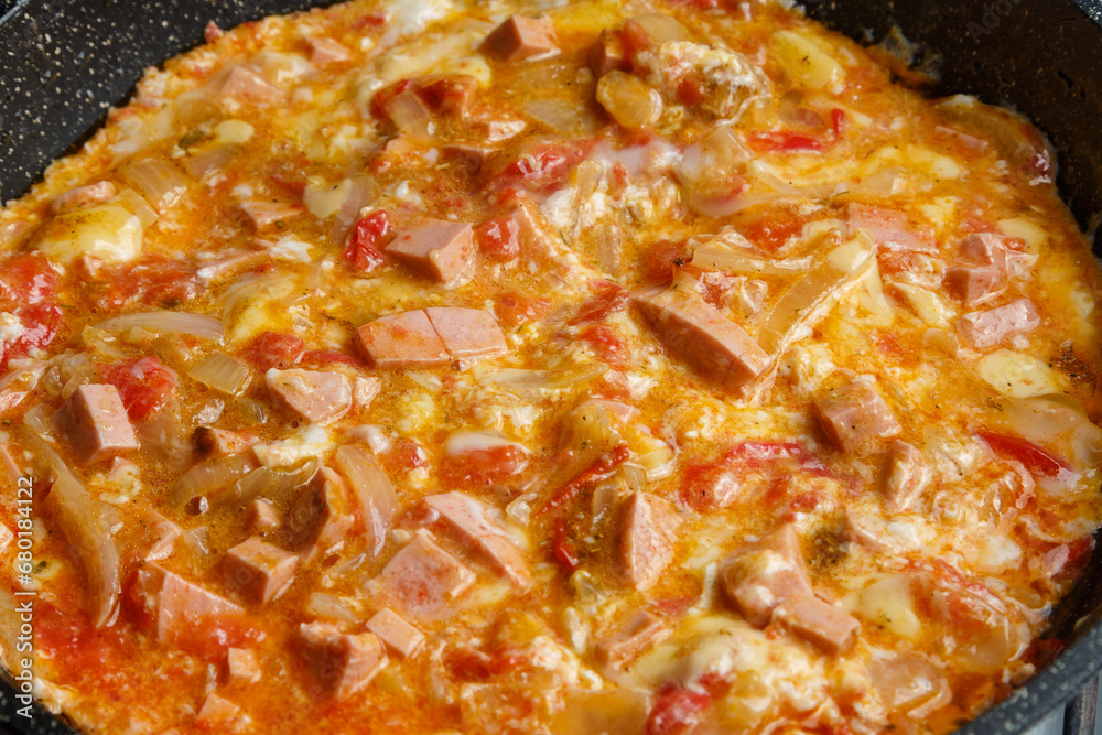 Shakshuka with tomatoes and sweet sprinkled with cheese juicy fresh close-up. Shakshuka with tomatoes and sweet sprinkled with cheese juicy fresh close-up.