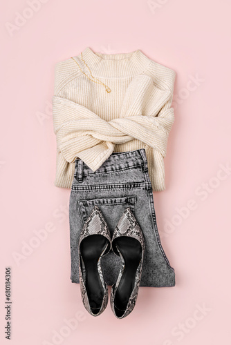 Jumper with jeans and loafers. Fashion spring, autumn or winter outfit. Women's stylish and elegant clothes with accessory and jewelry. Flat lay, top view, overhead.