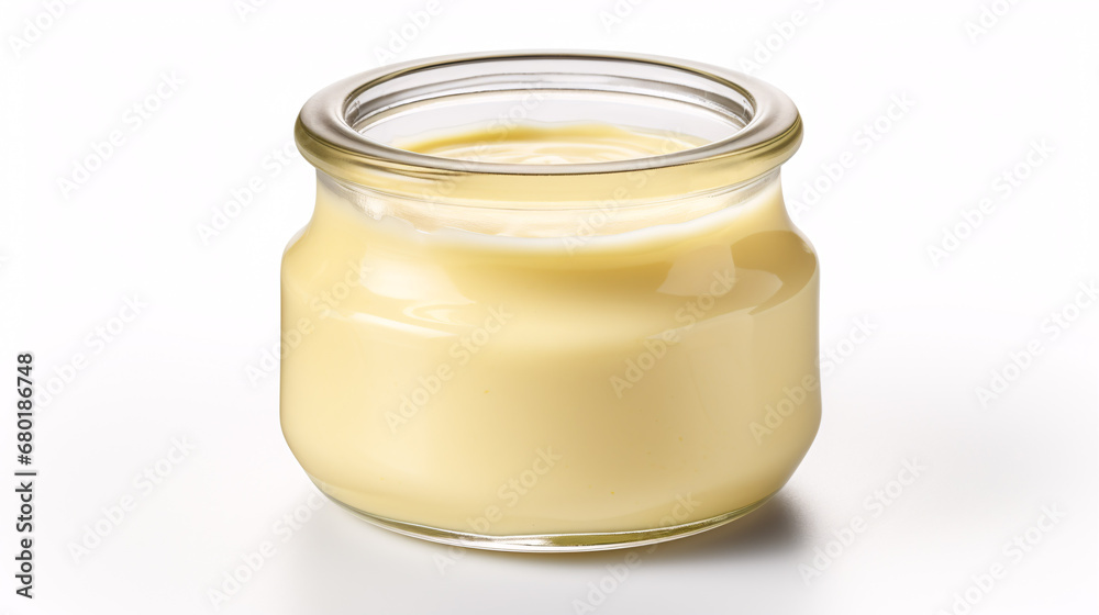 A delectable mayonnaise in a glass container, isolated on a white surface. A delectable mayonnaise in a glass container, isolated on a white surface.