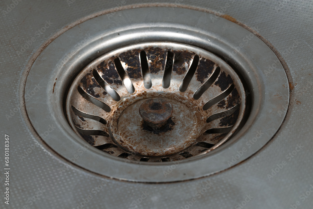 Hole in a kitchen metal sink. Rusty sink drain hole Hole in a kitchen metal sink. Rusty sink drain hole