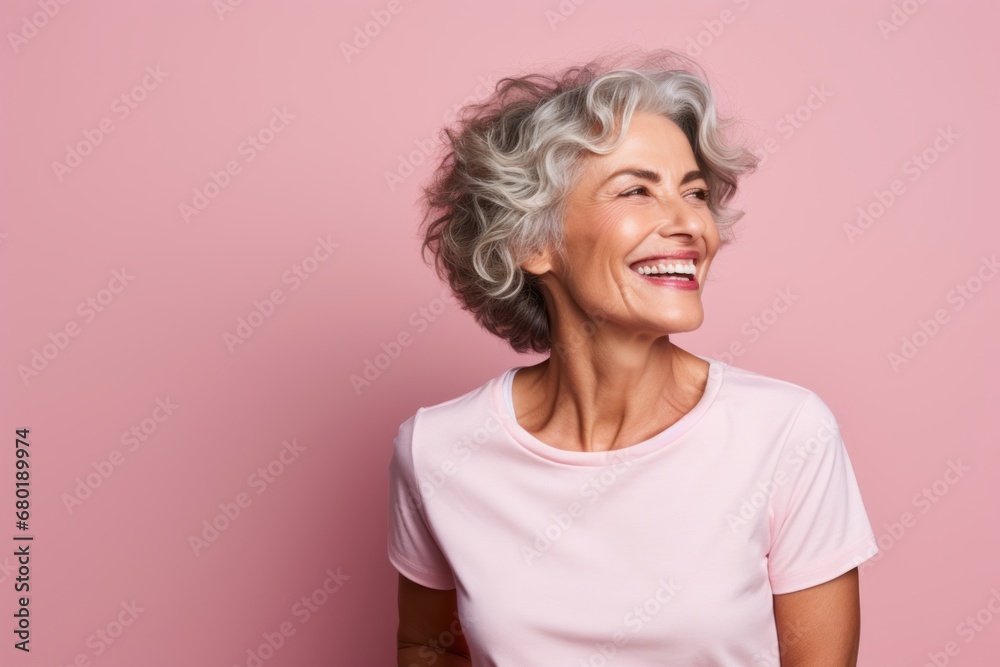 Portrait of a grinning woman in her 50s wearing a sporty polo shirt against a pastel pink background. AI Generation Portrait of a grinning woman in her 50s wearing a sporty polo shirt against a pastel pink background. AI Generation